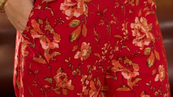 Red floral print wide leg pants with hand in pocket