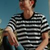 shallow focus photo of woman in white and black striped crew-neck T-shirt