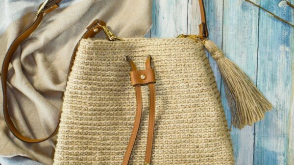 a straw bag sitting on top of a bed