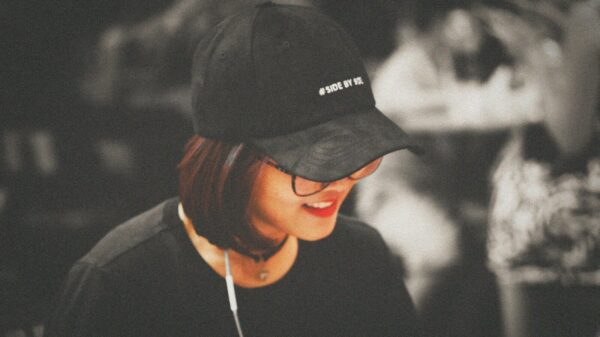 selective color photography of woman wearing black fitted cap