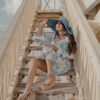 a woman sitting on a wooden staircase
