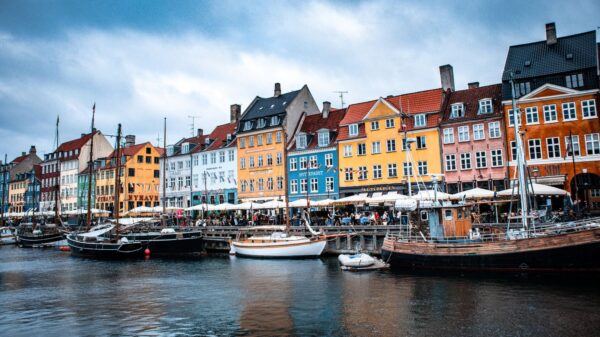 Vibrant boats and colorful buildings at Nyhavn harbor, Copenhagen's iconic waterfront.