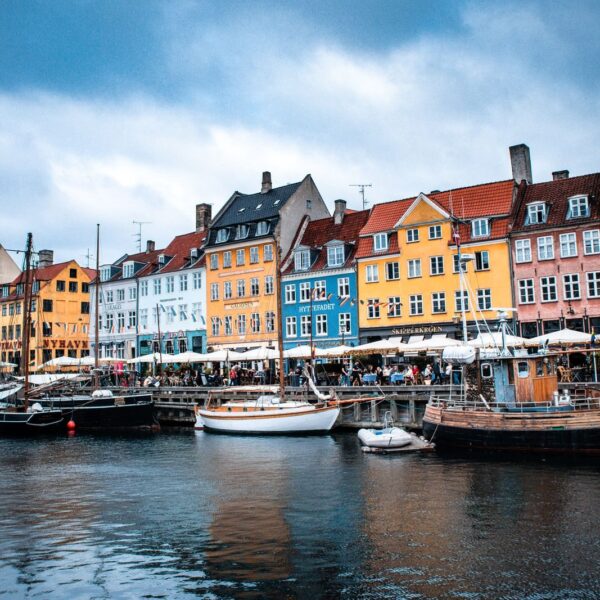 Vibrant boats and colorful buildings at Nyhavn harbor, Copenhagen's iconic waterfront.