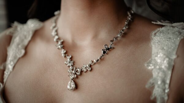 Close-up of a woman wearing a floral design wedding necklace, exuding elegance.
